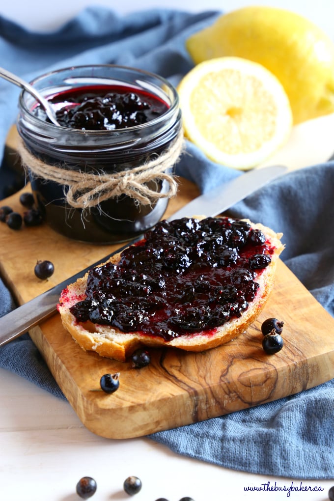 Best Ever Black Currant Jam on crusty bread with jar and knife