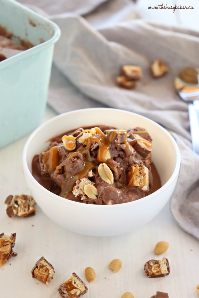 Easy No Churn Snickers Ice Cream in white bowl with snickers bar