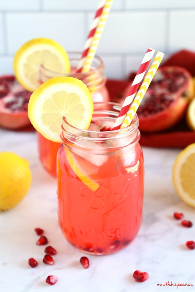 Healthy Pomegranate Lemonade in mason jar with lemon slices and pomegranate seeds