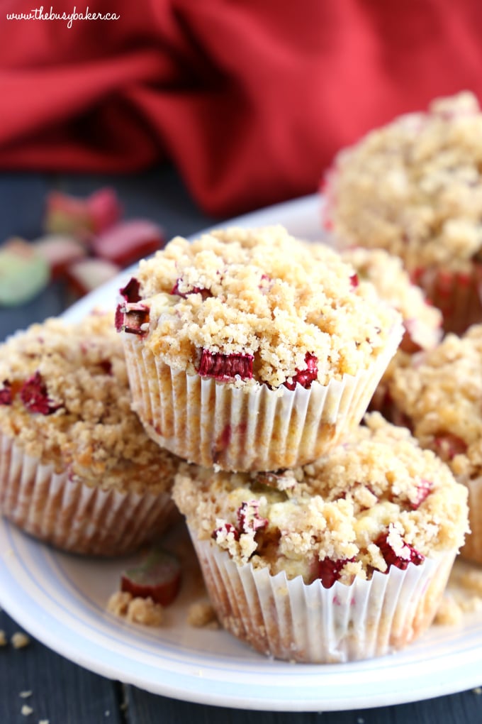 Best Ever Rhubarb Streusel Muffins on plate with red towel and crumbs