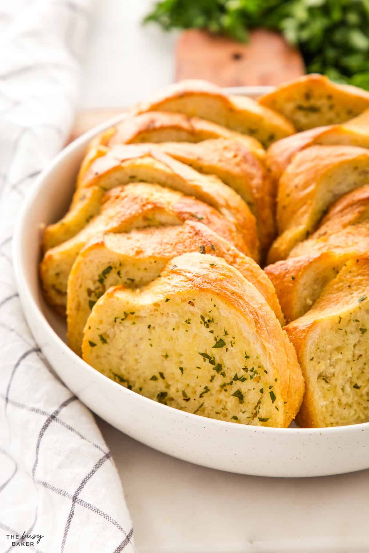 golden brown garlic bread in a white bowl