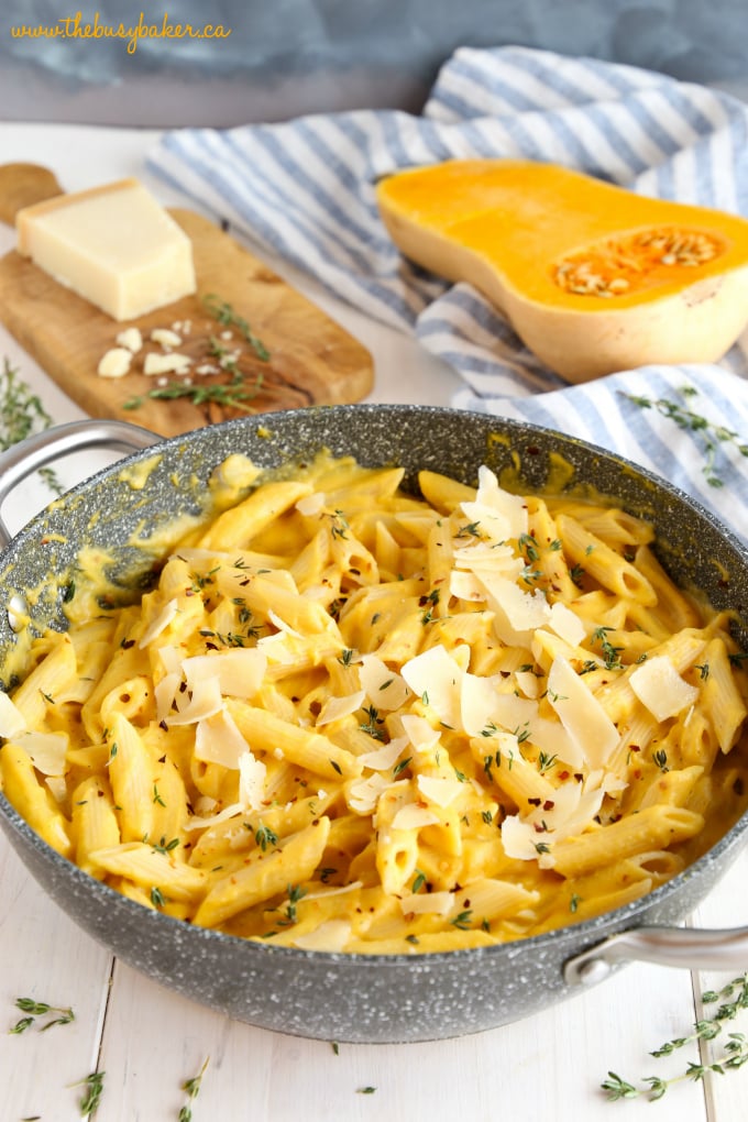 Creamy One Pot Butternut Squash Pasta in pot with parmesan cheese and thyme