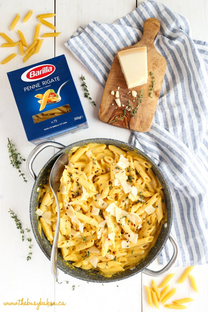 Creamy One Pot Butternut Squash Pasta in pot with parmesan cheese and thyme