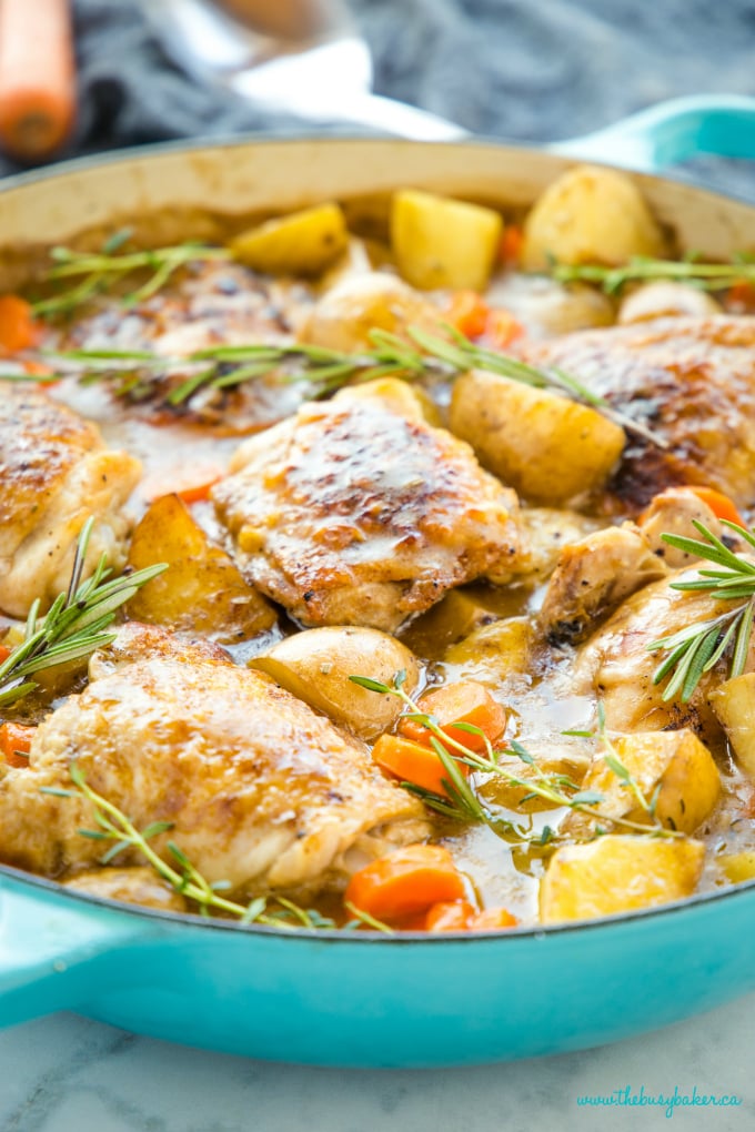 Easy One Pot Roasted Chicken Dinner in turquoise pan with fresh herbs