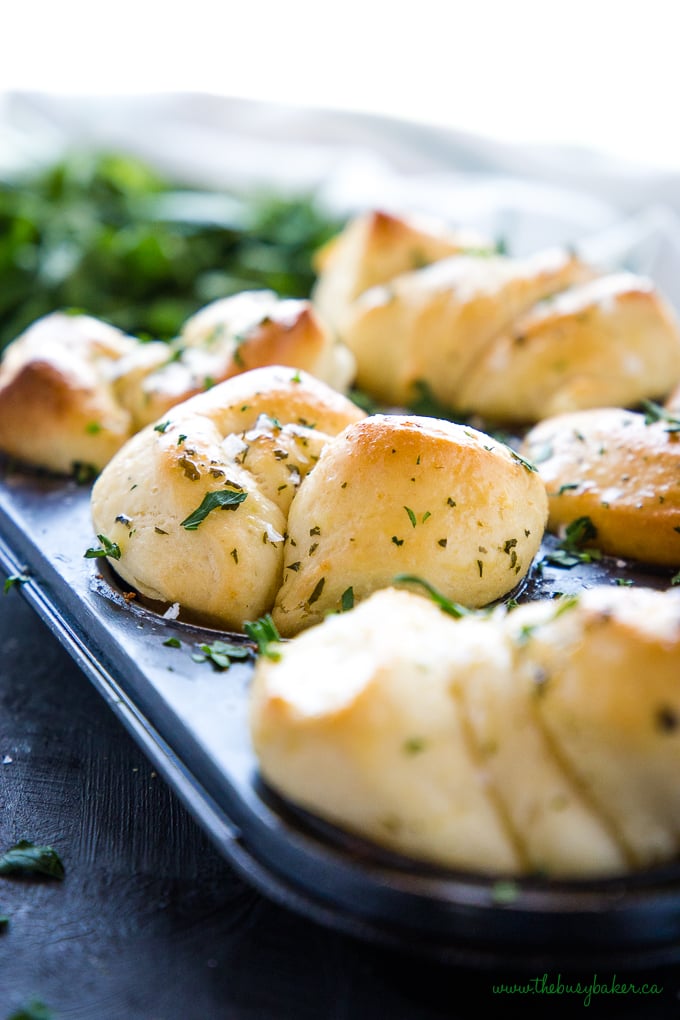 Easy Homemade Garlic Butter Dinner Rolls in muffin tin with sea salt