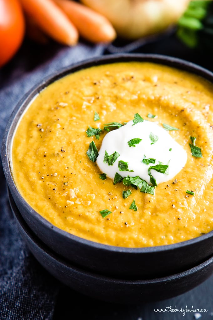 Easy Healthy Roasted Vegetable Soup in black bowls with coconut cream and fresh herbs