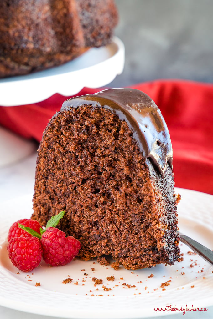 Chocolate Pudding bundt Cake with three raspberries beside