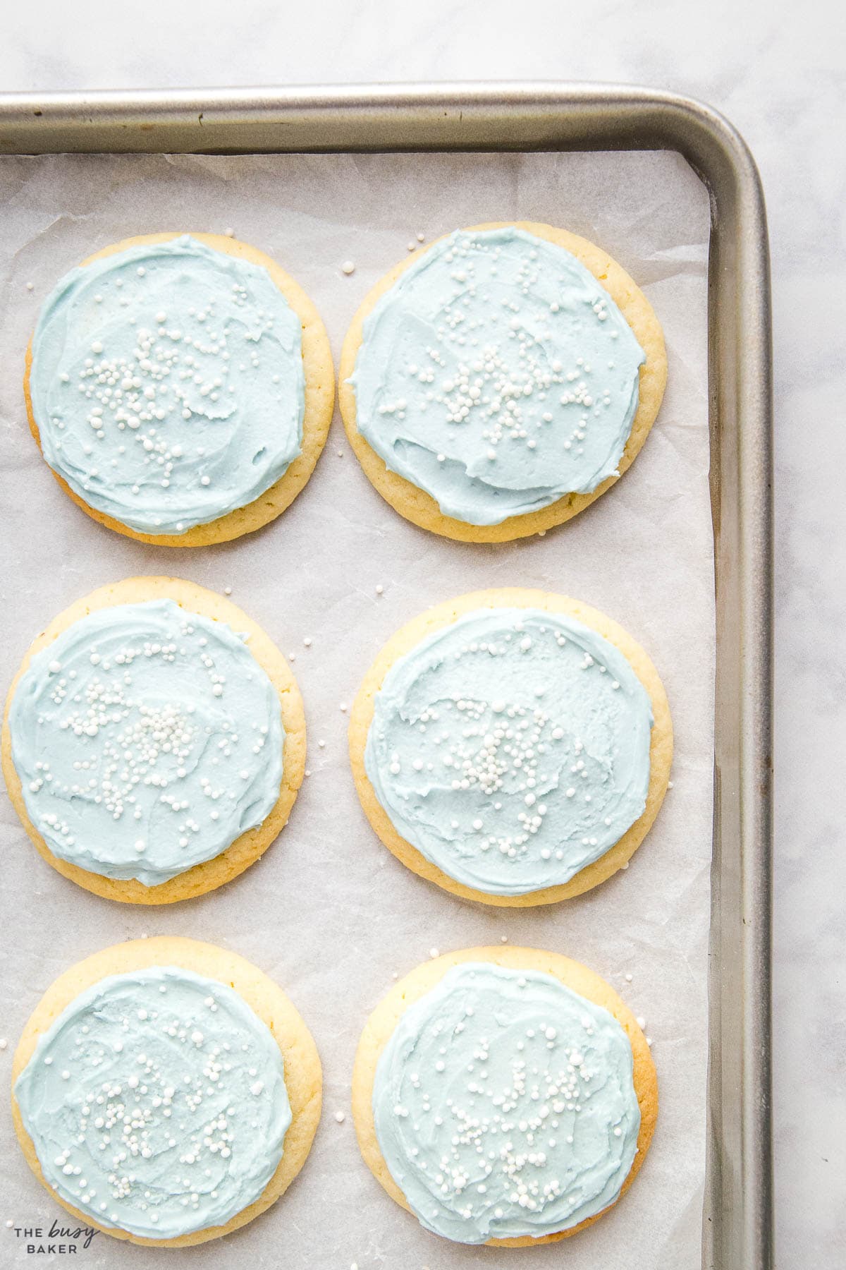 sugar cookies with blue frosting and sprinkles