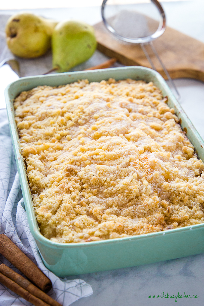 Pear Streusel Cake in green pan with powdered sugar