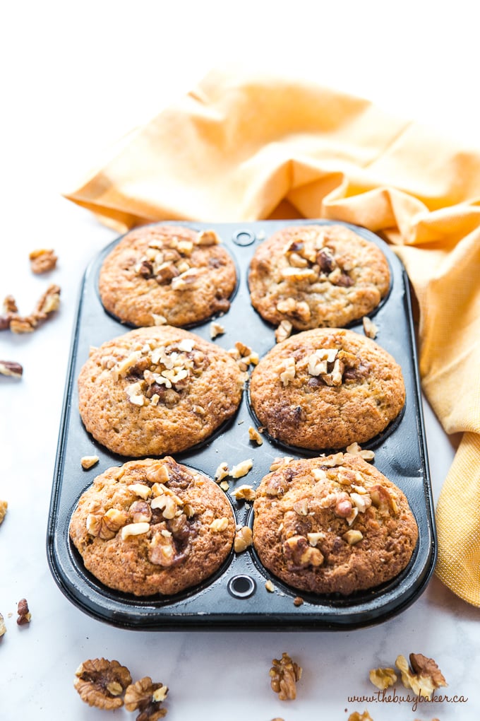 Best Ever Banana Nut Muffins in muffin tin with yellow towel