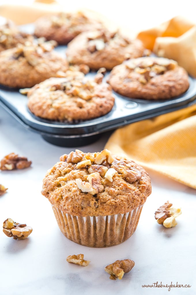 Best Ever Banana Nut Muffins with walnuts and yellow towel