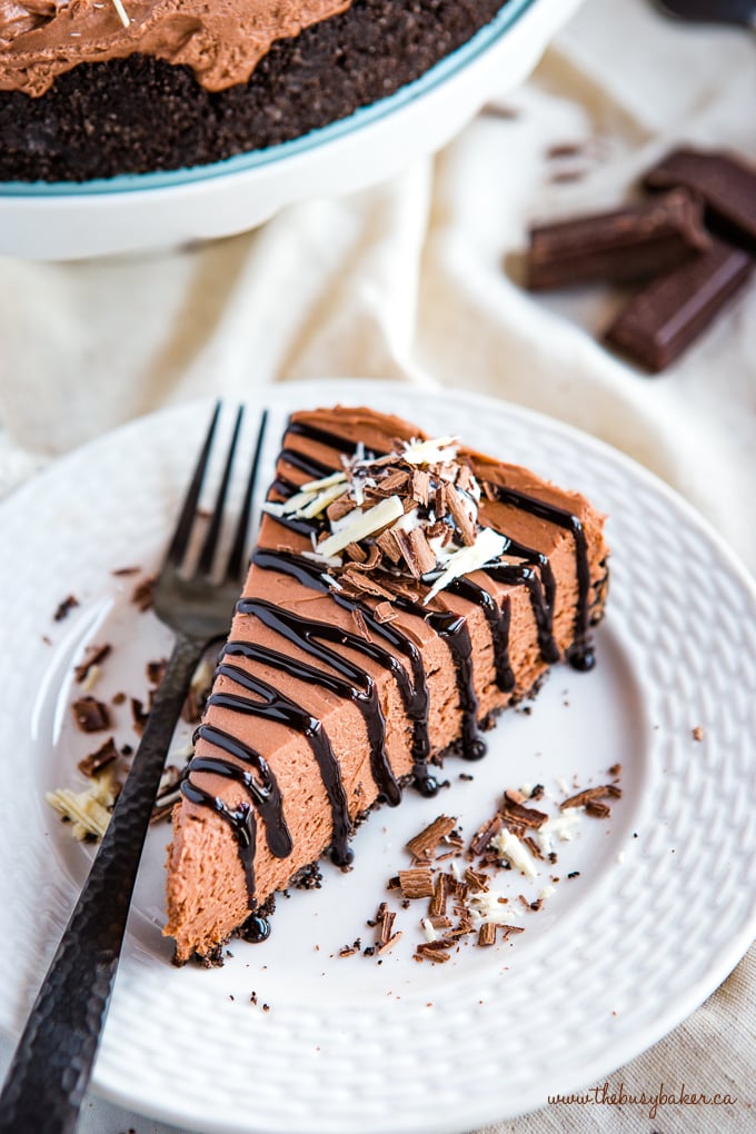 Easy No Bake Triple Chocolate Cheesecake on white plate with black fork