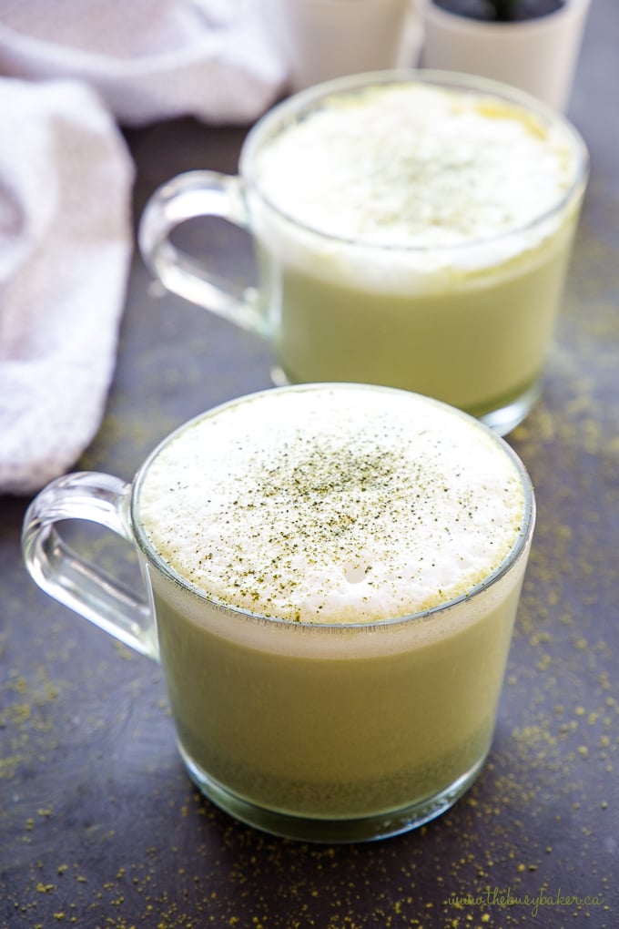 Healthy Matcha Latte in glass mug with foam with matcha powder