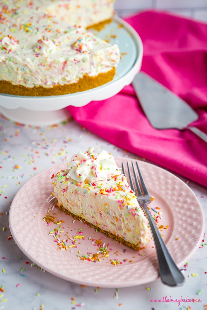 Slice of Easy No Bake Funfetti Cheesecake with whipped cream