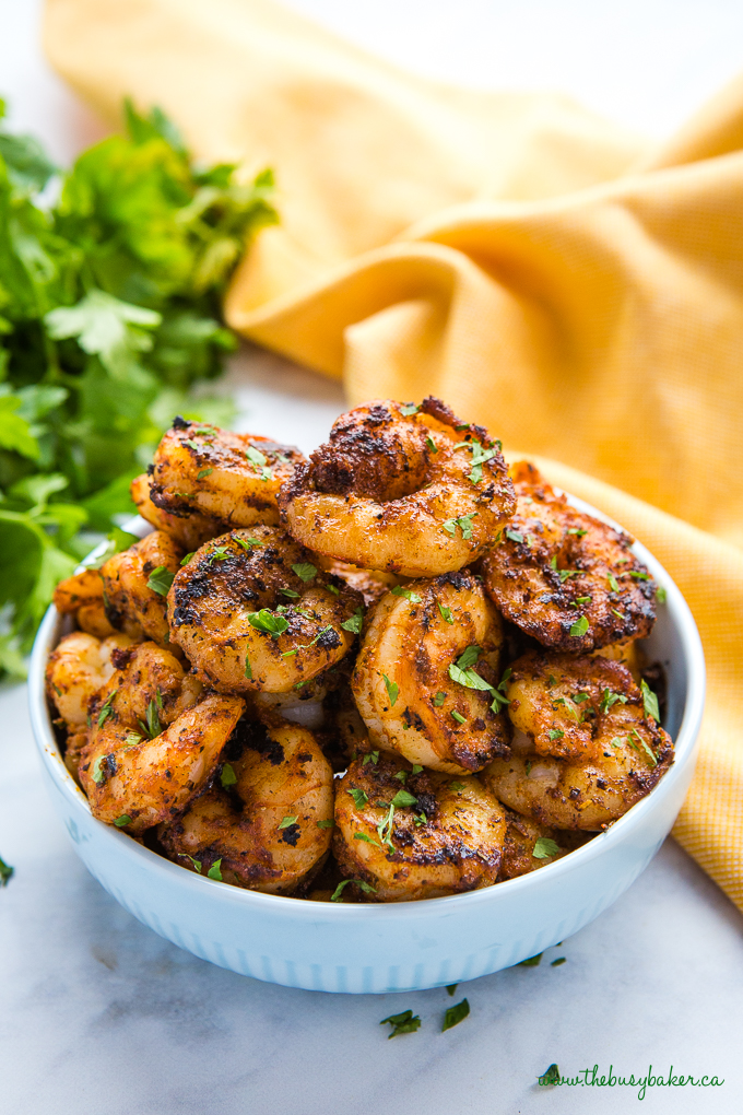 Easy One Pan Cajun Shrimp in blue bowl with herbs