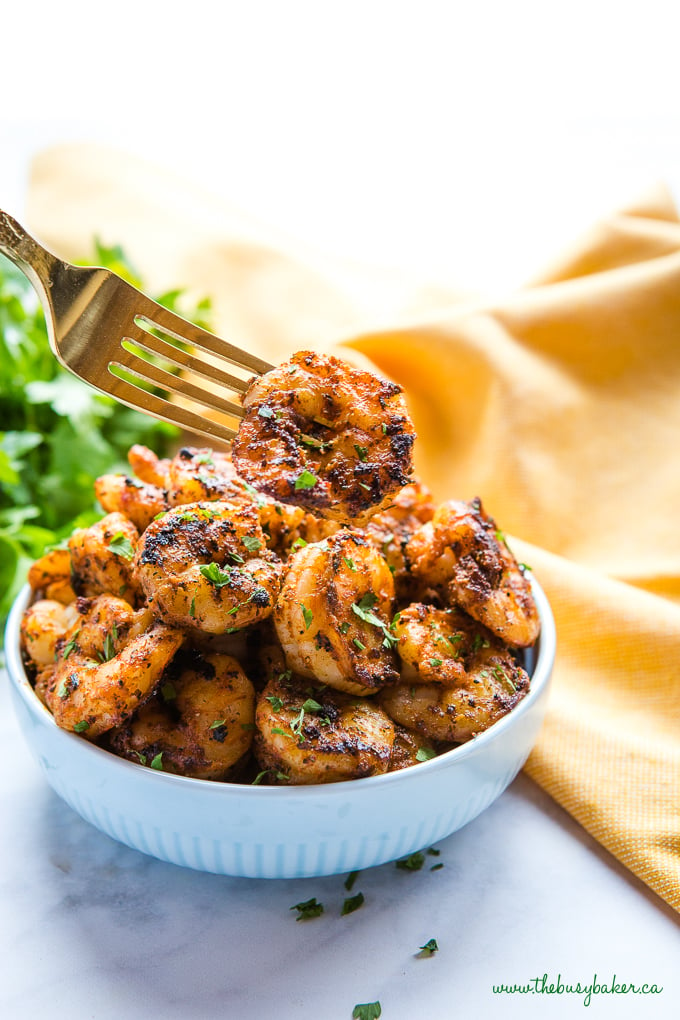 Easy One Pan Cajun Shrimp in blue bowl with fork