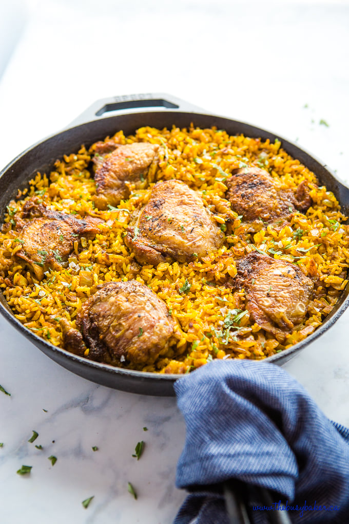 Easy One Pan Chicken with Turmeric Rice in cast iron pan on marble