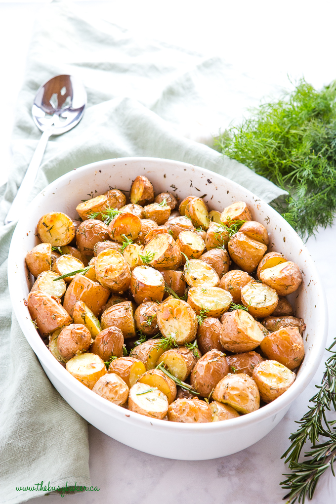 Rosemary Dill Roasted Potatoes in white dish with fresh herbs