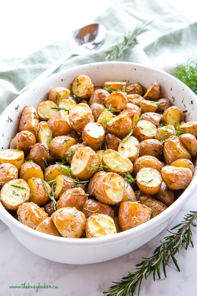 Rosemary Dill Roasted Potatoes in white dish with fresh herbs