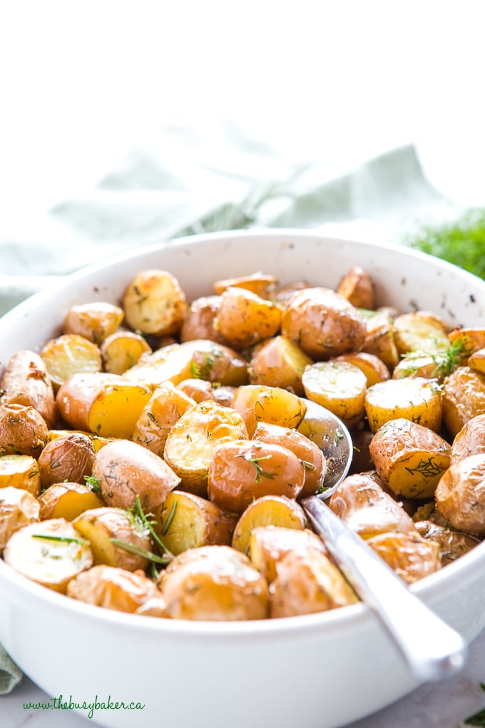 Rosemary Dill Roasted Potatoes in white dish with fresh herbs