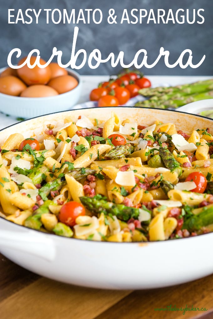 Easy 20-Minute Tomato Asparagus Carbonara Pasta in white casserole dish with fresh veggies and bacon