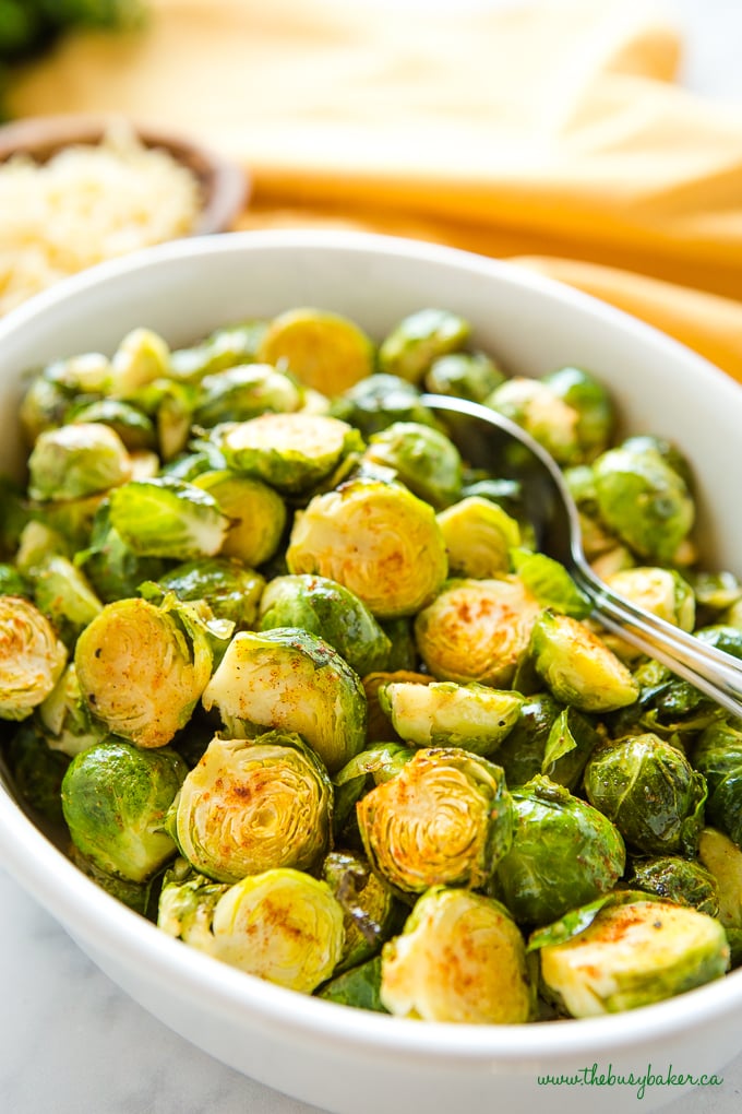 Easy Oven Roasted Brussels Sprouts in white casserole dish 