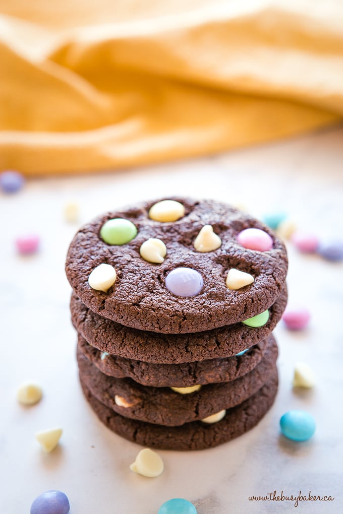 These Easter Double Chocolate Cookies are the perfect fun and easy Easter treat! Crispy on the outside, chewy on the inside, and packed with candy-coated chocolate and white chocolate! Easter Double Chocolate Cookies with Spring M&Ms in stack