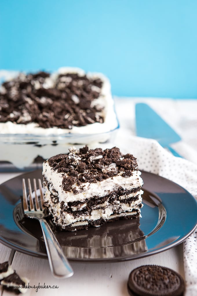 No Bake Cookies and Cream Oreo Icebox Cake on black plate with blue background