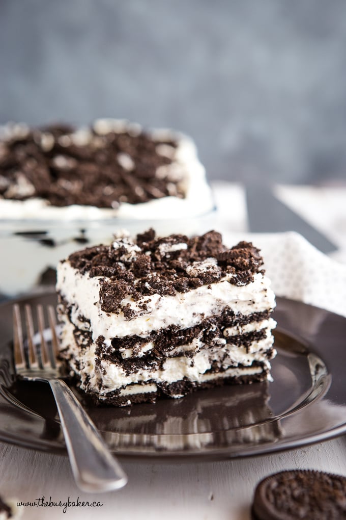 slice of Oreo Icebox Cake on black plate with fork