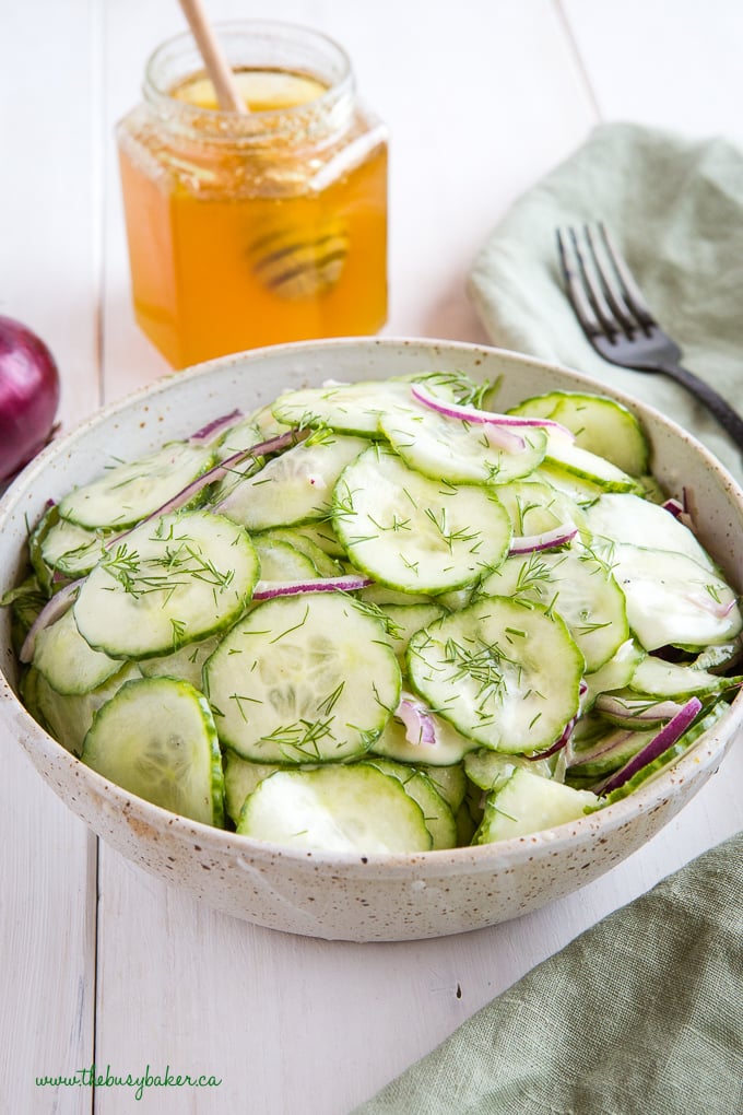 Cucumber salad with dill in pottery bowl