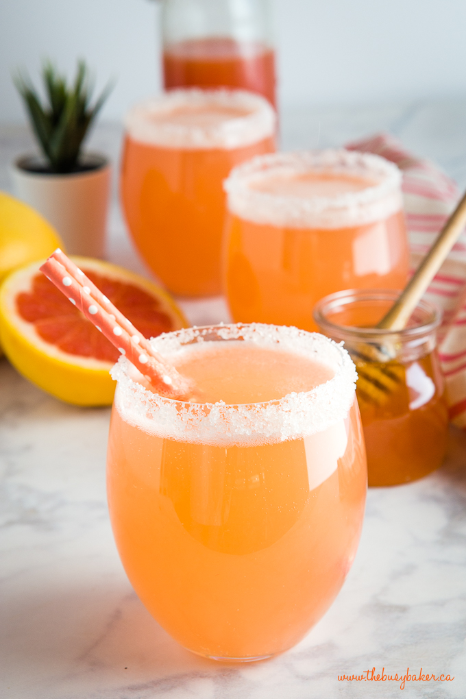 pink grapefruit soda in glass with paper straws