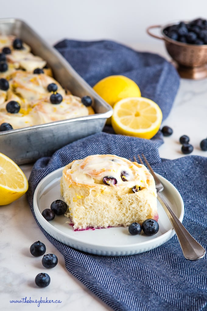 lemon blueberry rolls on blue plate with fork