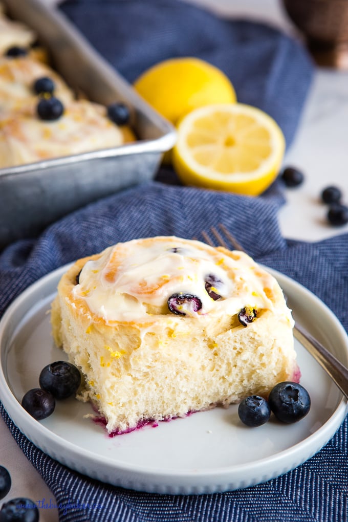 lemon blueberry rolls on plate with fresh blueberries