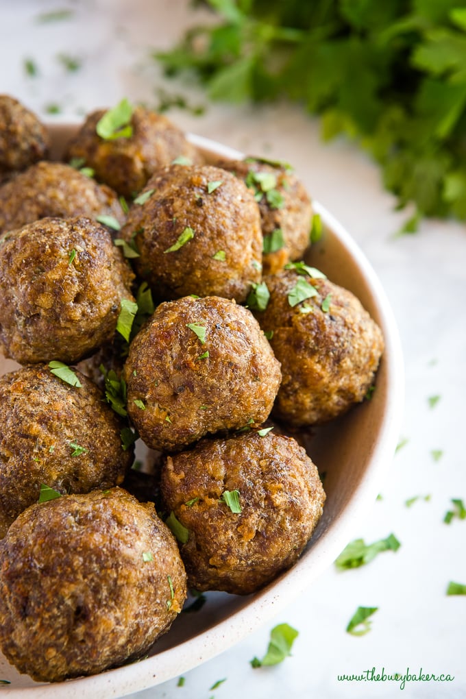 meatballs in bowl with green herbs