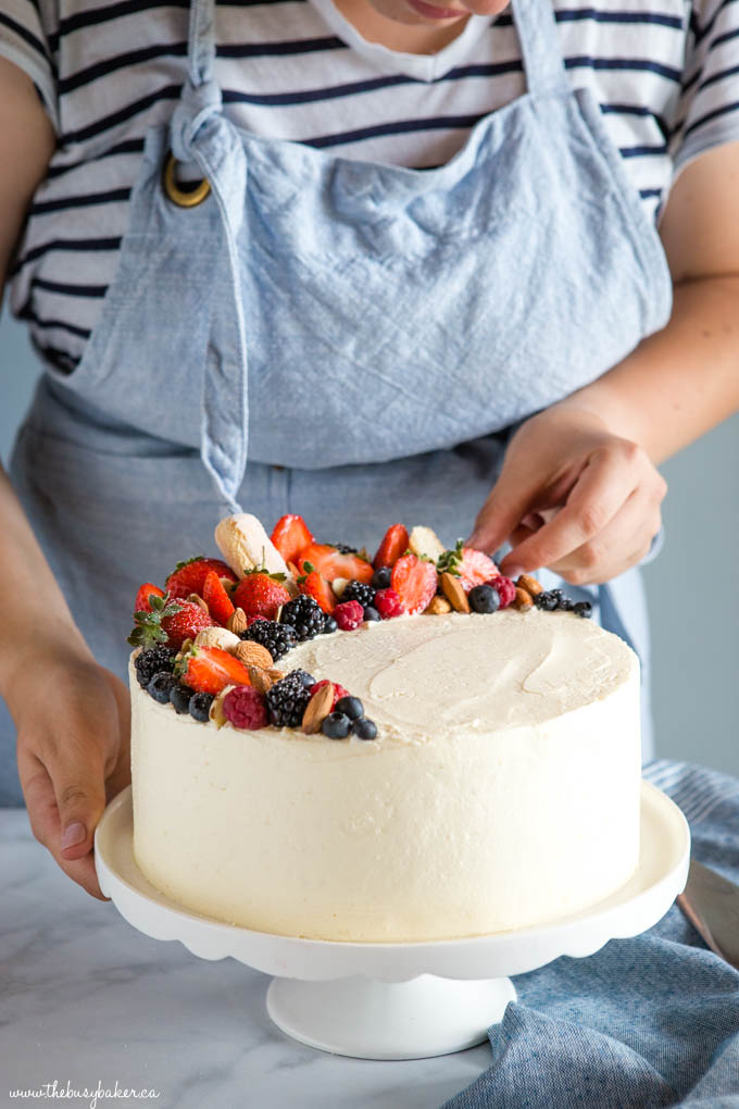 Almond Cream Cake with baker in background in apron