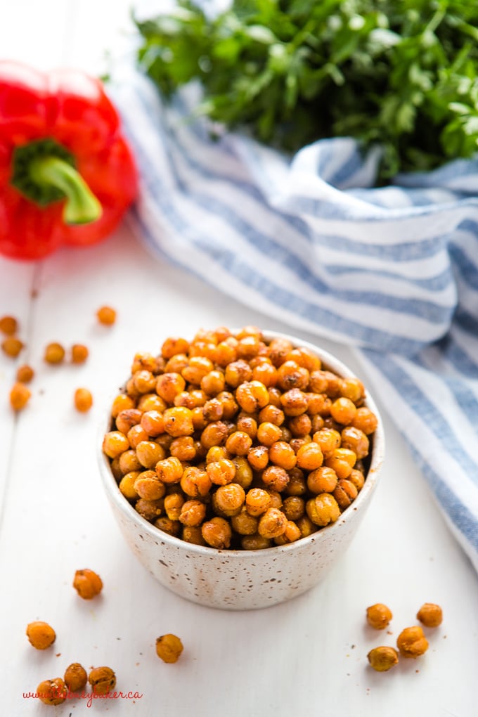 barbecue roasted chickpeas in pottery bowl with herbs and red pepper