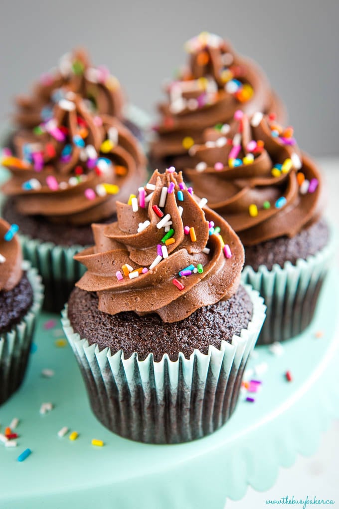 chocolate cupcake recipe made from scratch - 3 cupcakes with sprinkles and swirls of chocolate frosting