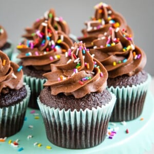 batch of chocolate cupcakes made from scratch with fluffy chocolate frosting and sprinkles