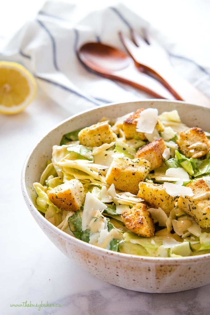 salad bowl filled with Romaine lettuce, shaved Parmesan cheese, croutons and creamy dressing