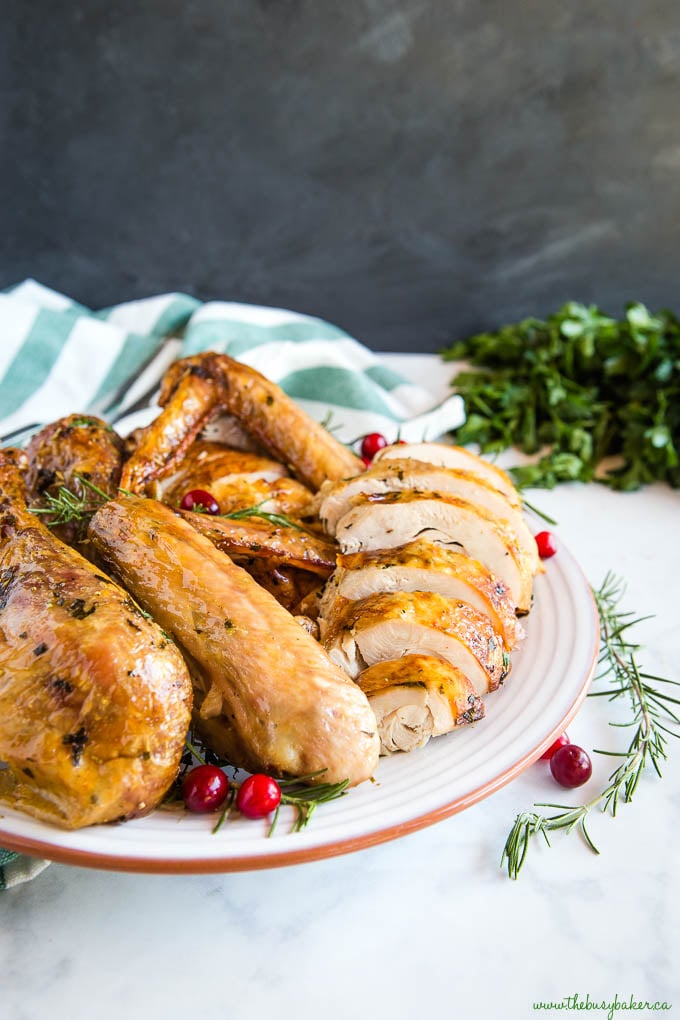 roasted turkey on terra cotta plate with cranberries and rosemary