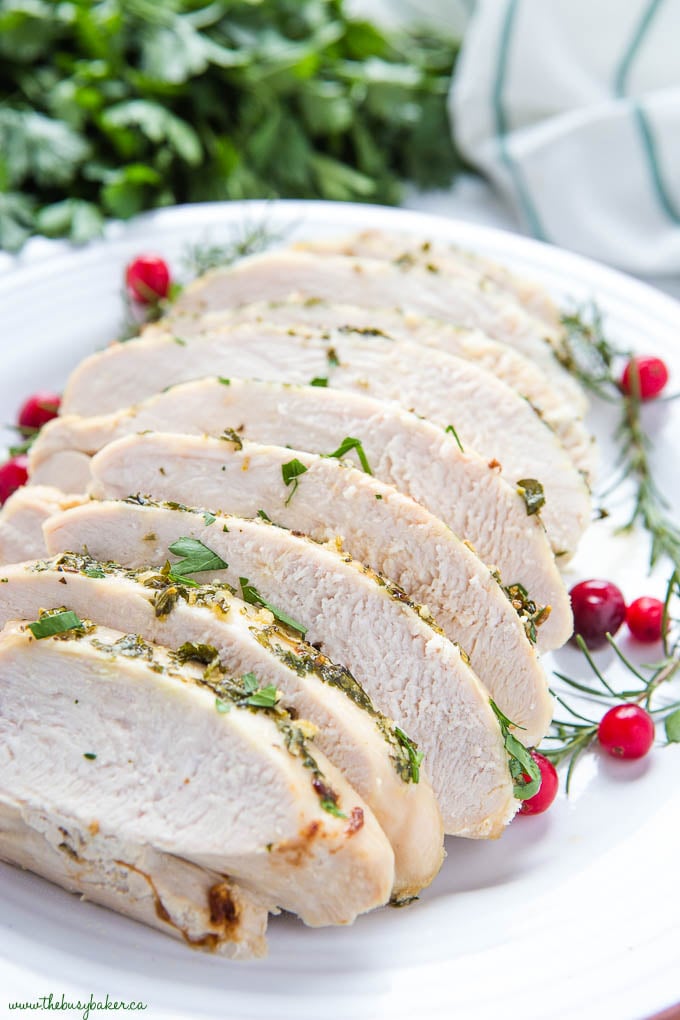 Sliced juicy roast turkey breast on white plate