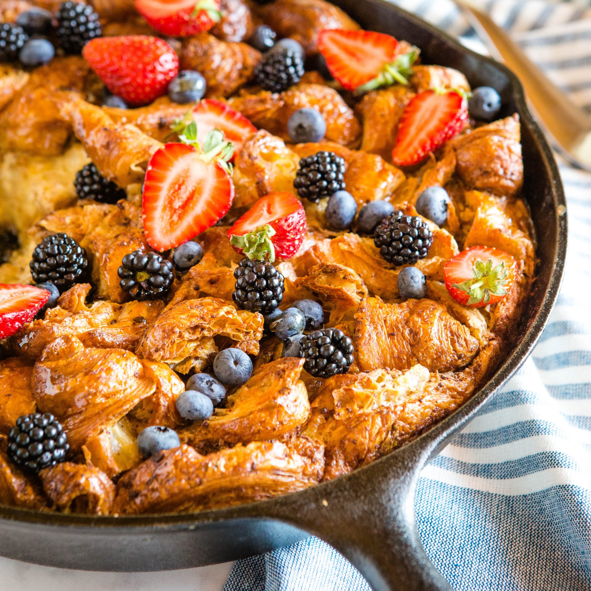 breakfast casserole with fresh berries in cast iron skillet