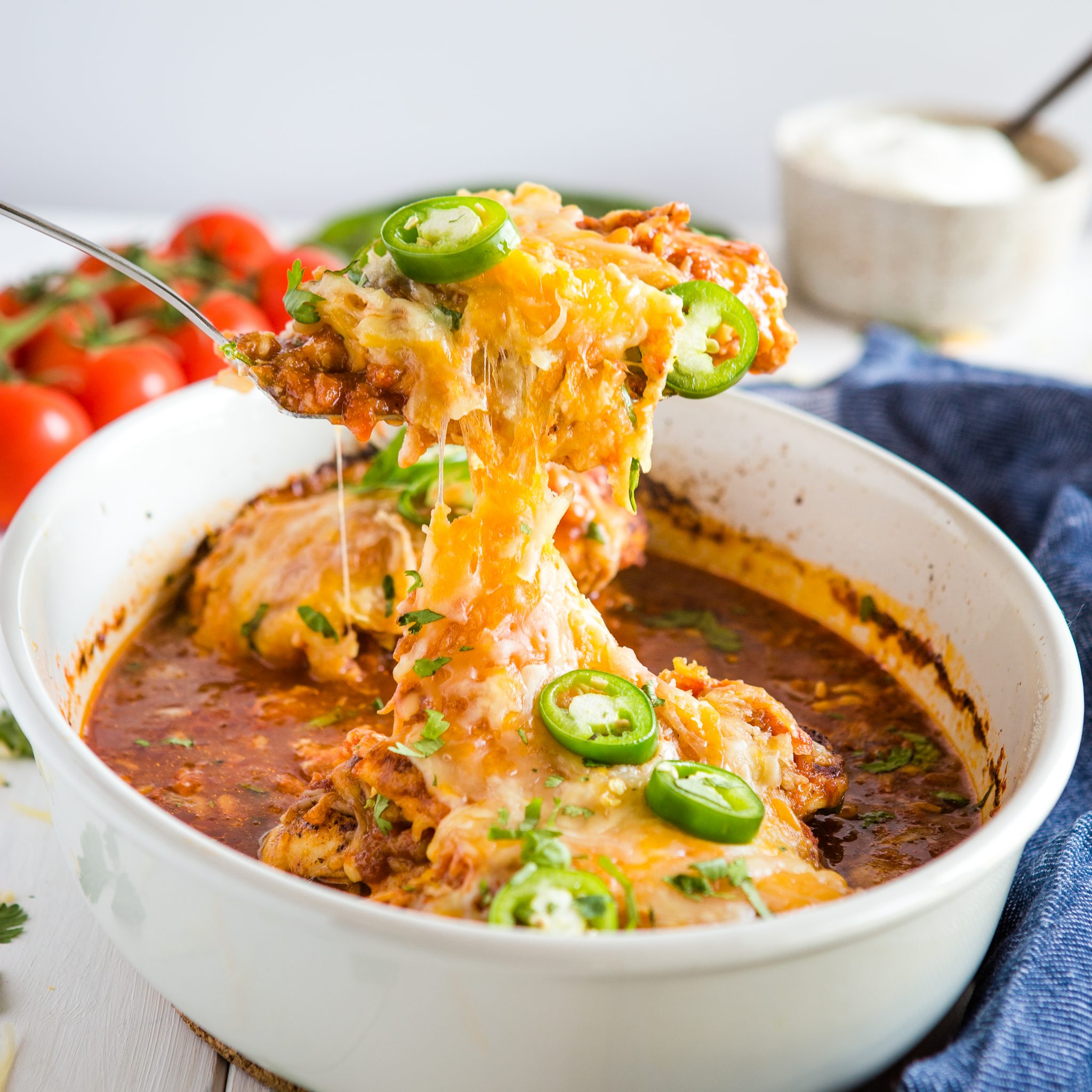 baked salsa chicken being served from a white pan