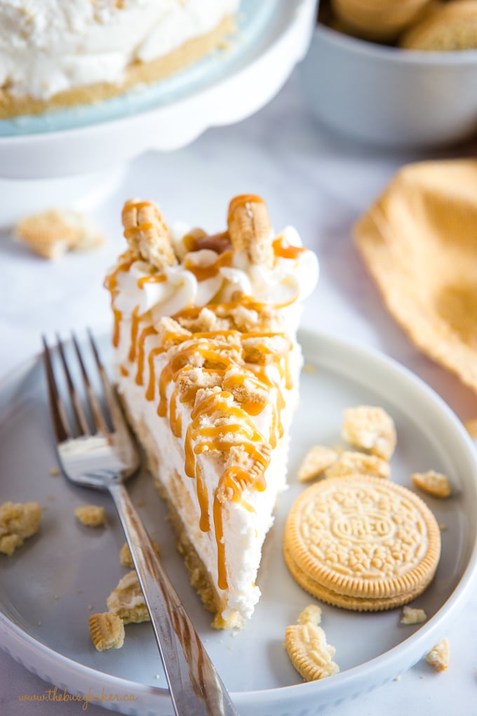 no bake cheesecake slice topped with Golden Oreo cookies and drizzle of caramel