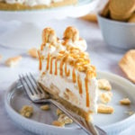 creamy slice of Golden Oreo cheesecake on white plate