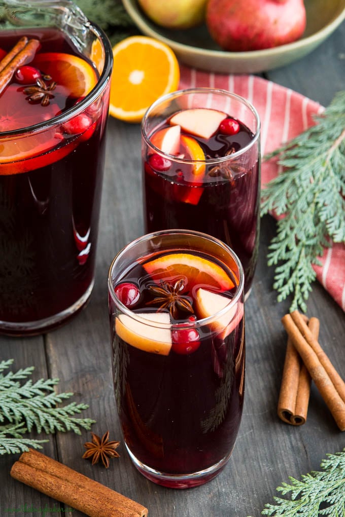 alcohol free sangria in pitcher with cranberries and cinnamon sticks