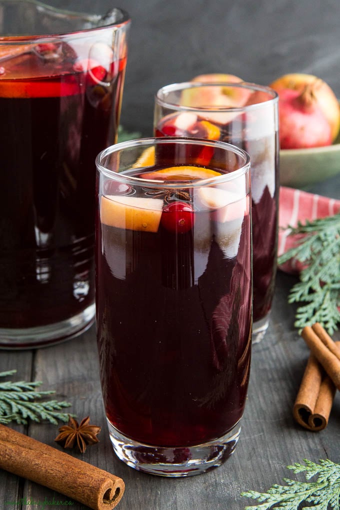 apple cranberry sangria in tall glass with cranberries