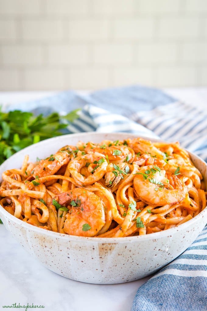 seafood marinara linguine in pottery bowl with shrimp and squid