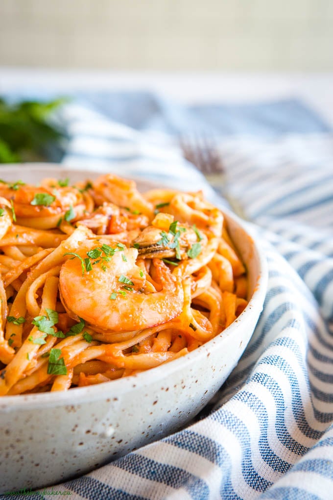 seafood marinara linguine with shrimp in pottery bowl