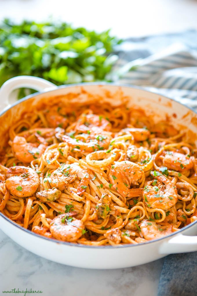 seafood marinara linguine in white cast iron pan